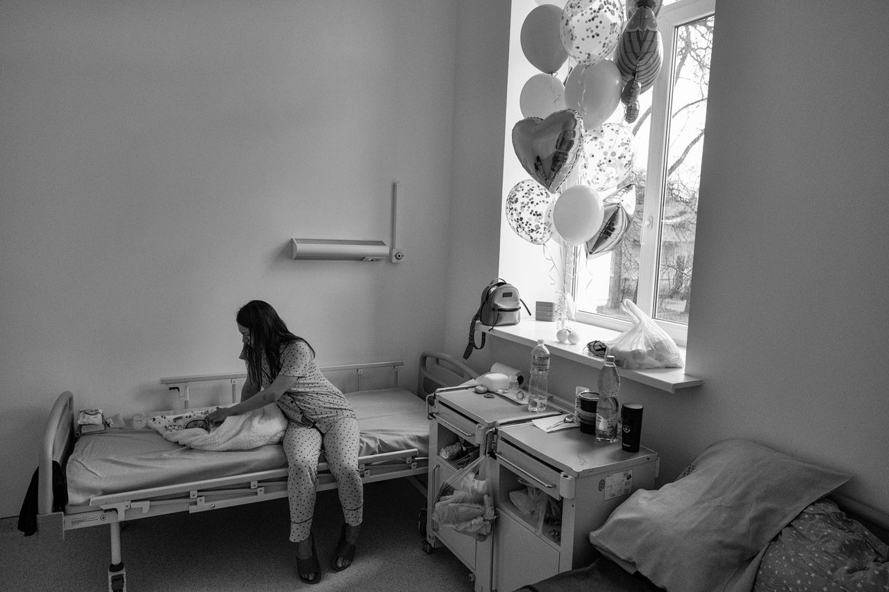 Iryna, a mother at the maternity ward in Lviv, watches her newborn baby.