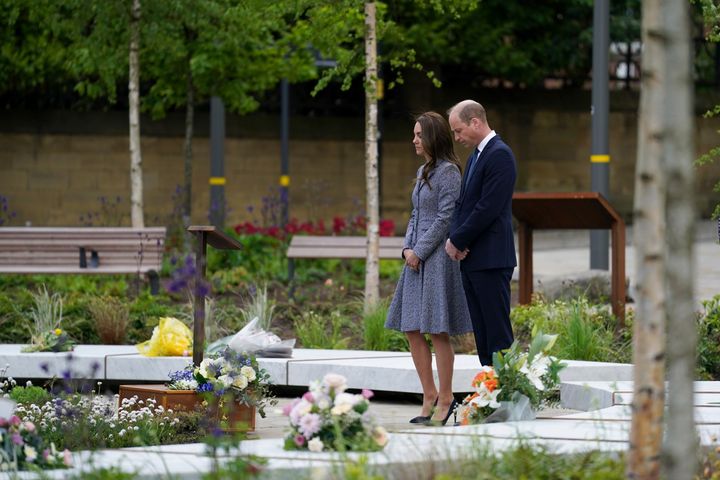 The Duke and Duchess of Cambridge bow their heads after the duchess laid flowers at the Glade of Light memorial garden.