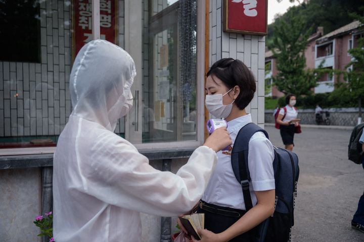 In this file photo from 2021, students of the Pyongyang Jang Chol Gu University of Commerce underwent temperature checks before entering the campus, as part of preventative measures against Covid-19.