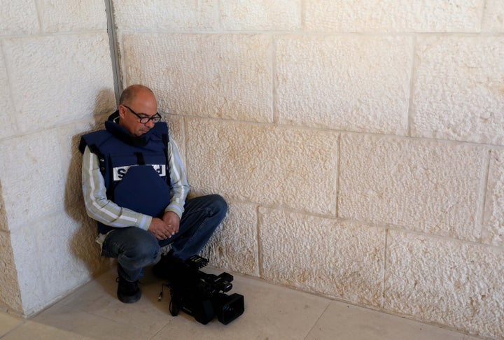 A journalist mourns following the killing of Al-Jazeera journalist Shireen Abu Akleh at a hospital in the West Bank city of Jenin, May 11, 2022. The Palestinian Health Ministry said in a statement that the reporter was shot while covering an Israeli military raid and died shortly after, adding that another Palestinian reporter was shot in the back during the raid. The ministry said Israeli troops shot Abu Akleh.