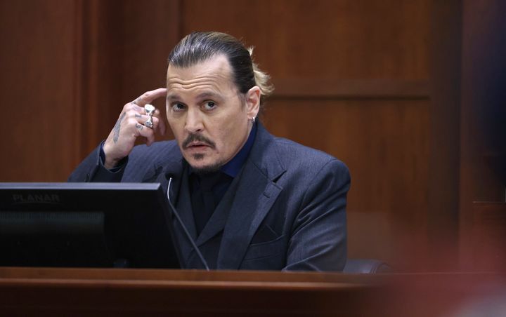 Actor Johnny Depp testifies in the courtroom at the Fairfax County Circuit Court on April 21, 2022.