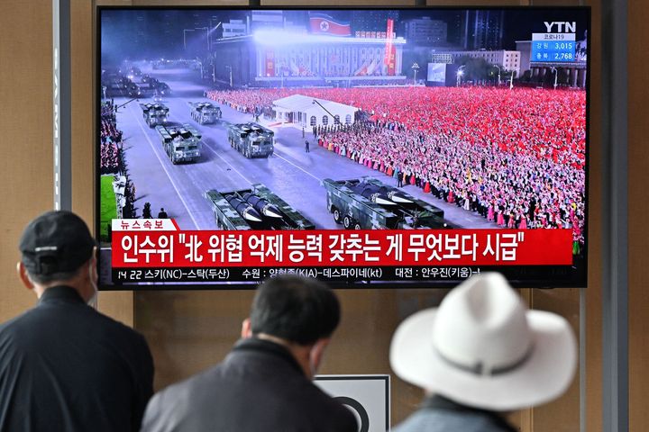 People in Seoul watch an April 25 news broadcast of a military parade in Pyongyang commemorating the 90th anniversary of the founding of the Korean People's Revolutionary Army. Some experts think the parade acted as a superspreader event for COVID-19 in North Korea.
