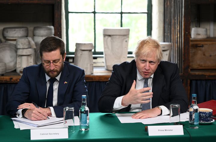 Prime Minister Boris Johnson flanked by Britain's Cabinet Secretary and Head of the Civil Service Simon Case.