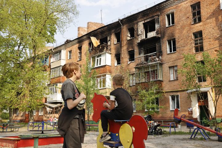 Ukrainian children play near damaged buildings as Russian attacks continue in Chernihiv Oblast, Ukraine on May 12, 2022. 