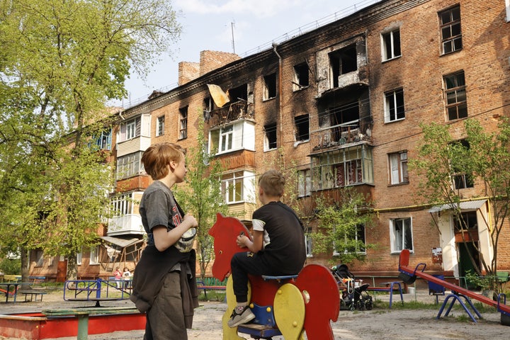 Ukrainian children play near damaged buildings as Russian attacks continue in Chernihiv Oblast, Ukraine on May 12, 2022.
