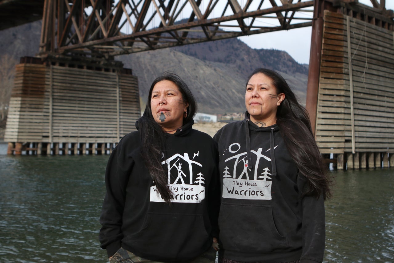 Kanahus and Mayuk Manuel stand near the Red Bridge in Kamloops, B.C. In September, Mayuk was injured and later arrested following a scuffle between protestors and Trans Mountain Pipeline security personnel in Blue River.