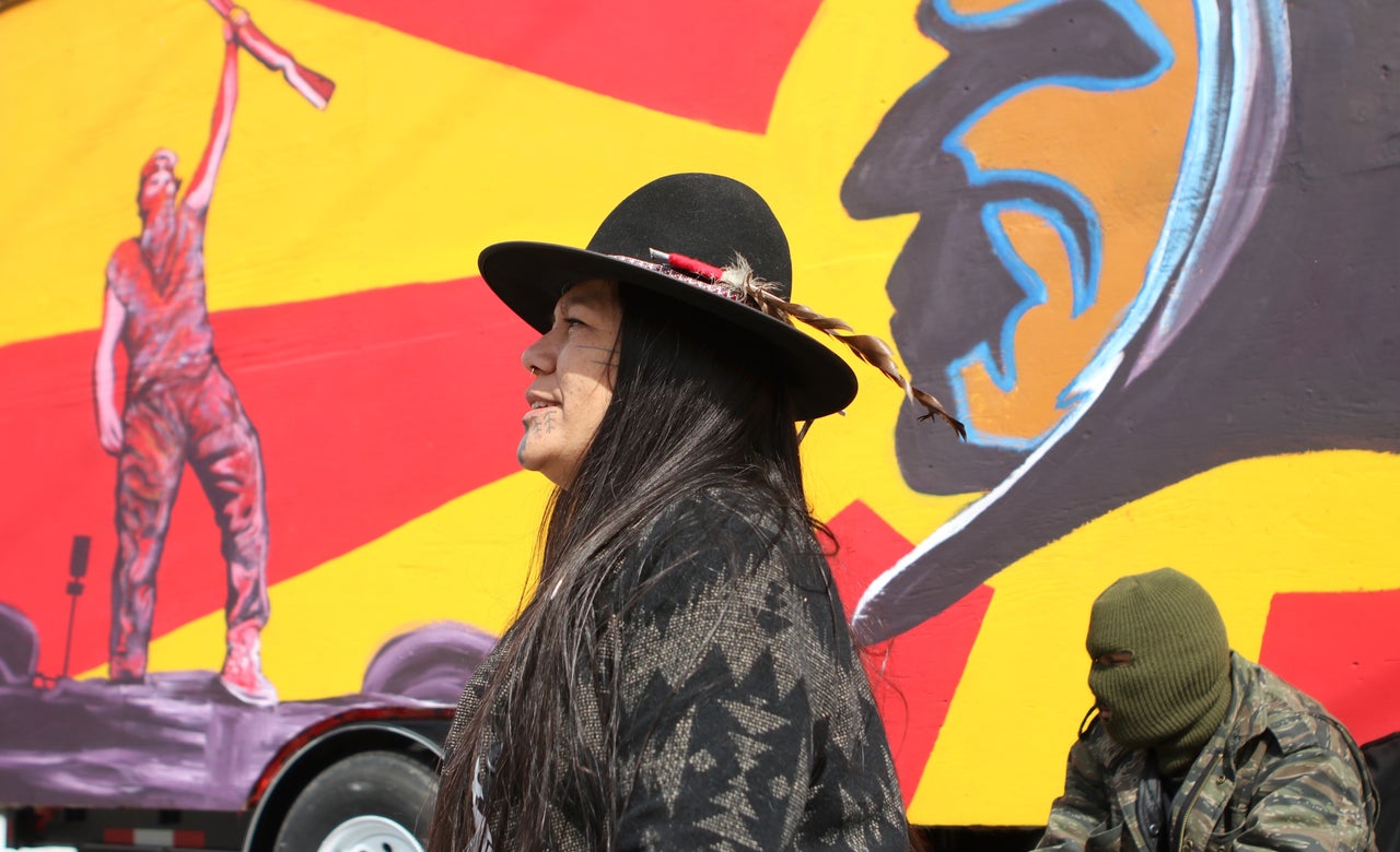 Kanahus Manuel, a member of the Tiny House Warriors, sits in front of a tiny home located in the Tiny House Warriors village in Blue River, B.C.