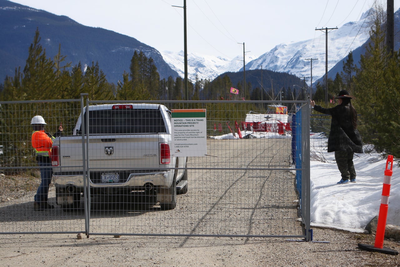 Tiny House Warriors member Kanahus Manuel gives the middle finger to a Trans Mountain Pipeline worker recording her on their cell phone outside of the security zone of a camp that houses Trans Mountain Pipeline workers.