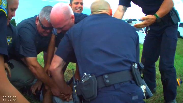 In this Saturday, May 23, 2020, image from Franklin Parish Sheriff's Office body camera video, law enforcement officers restrain Black motorist Antonio Harris on the side of a road after a high-speed chase in Franklin Parish, Louisiana. 