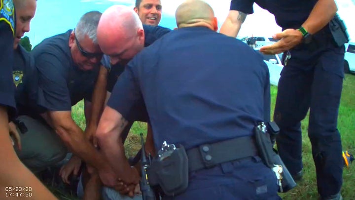 In this Saturday, May 23, 2020, image from Franklin Parish Sheriff's Office body camera video, law enforcement officers restrain Black motorist Antonio Harris on the side of a road after a high-speed chase in Franklin Parish, Louisiana.