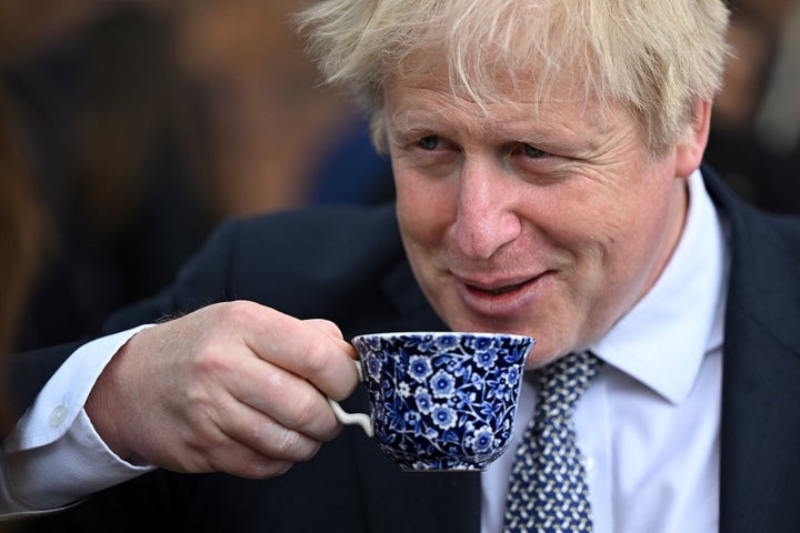 Boris Johnson drinks from a cup as he talks to local business people after a regional cabinet meeting at Middleport Pottery in Stoke on Trent on Thursday.