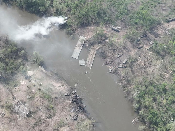 In this handout photo provided by the Ukraine Armed Forces on Thursday, May 12, 2022, a ruined pontoon crossing with dozens of destroyed or damaged Russian armored vehicles on both banks of Siverskyi Donets River after their pontoon bridges were blown up in eastern Ukraine. (Ukrainian Presidential Press Office via AP)