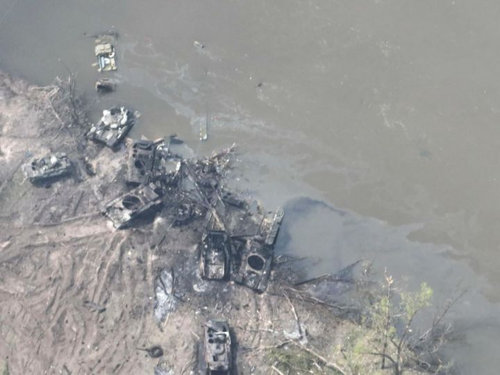 In this handout photograph  provided by the Ukraine Armed Forces connected  Thursday, May 12, 2022, dozens of destroyed oregon  damaged Russian armored vehicles are seen connected  some  banks of Siverskyi Donets River. (Ukrainian Presidential Press Office via AP)