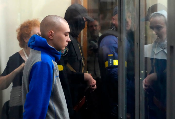 Russian army Sergeant Vadim Shishimarin, 21, is seen behind a glass during a court hearing in Kyiv, Ukraine, Friday, May 13, 2022. (AP Photo/Efrem Lukatsky)