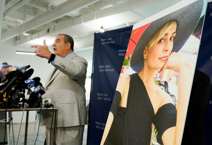 Brian Panish, an attorney for the family of the late cinematographer Halyna Hutchins, speaks next to a portrait of Hutchins at a Feb. 15 news conference in Los Angeles. Hutchins' family is suing Alec Baldwin and the "Rust" producers for wrongful death.