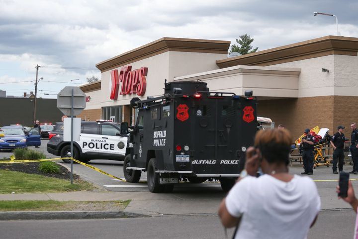 A crowd gathers as police investigate after a shooting at a supermarket on Saturday in Buffalo, New York. 