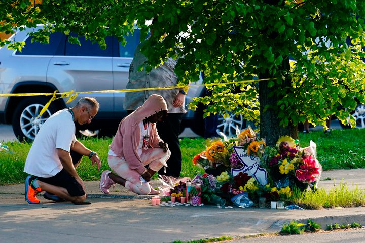 People pay their respects outside the scene of a shooting at a supermarket in Buffalo, New York, on Sunday.