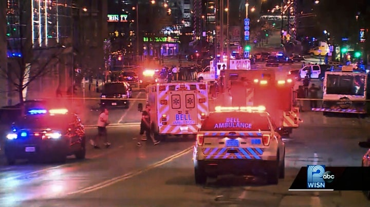 This photo taken from video provided by WISN 12 News shows police responding to the scene of a shooting at Water Street and Juneau Avenue in Milwaukee, Friday, May 13, 2022. Twenty people were injured in two shootings in downtown Milwaukee near an entertainment district where thousands of people were watching the Bucks play the Celtics in the NBA's Eastern Conference semifinals, authorities said. There was no immediate indication whether the two shootings were related or involved fans who were watching the game. (WISN 12 News via AP)