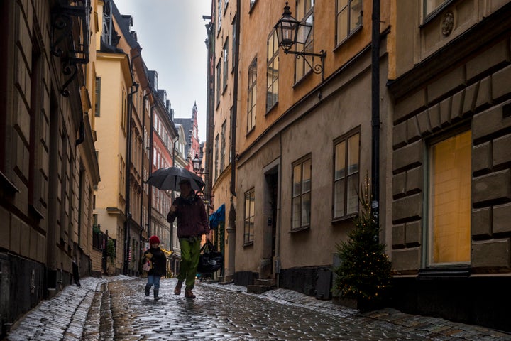 STOCKHOLM- SWEDEN - DECEMBER 4: Father and son walk through the empty streets of the old town on December 4, 2020 in Stockholm, Sweden. Usually at this time of year, the neighborhood is filled with tourists and Christmas activities. Over 7,000 people have died of COVID-19 in Sweden, giving the country of 10.2 million one of Europe's highest death rates per capita. (Photo by Jonas Gratzer/Getty Images)