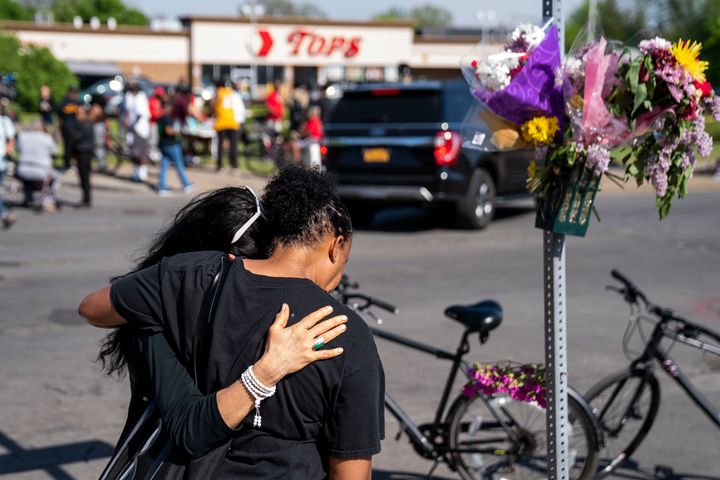 Jeanne LeGall, of Buffalo, hugs Claudia Carballada, of Buffalo, as she gets emotional, as she pays her respects at an makeshift memorial as people gather at the scene of a mass shooting at Tops Friendly Market.