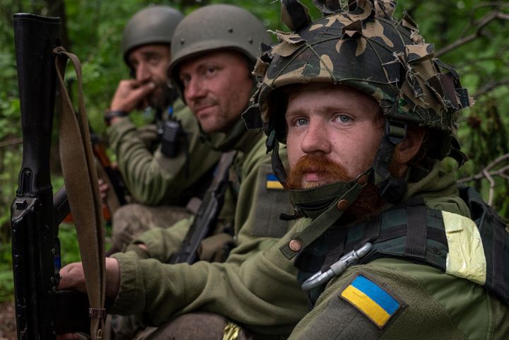Ukrainian servicemen take rest in a recently retaken village north of Kharkiv, east Ukraine, on May 15, 2022.