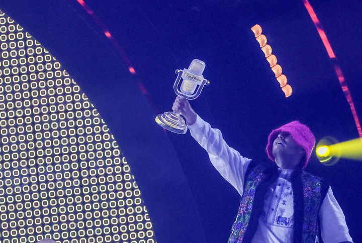 Oleg Psiuk holds the Eurovision trophy aloft
