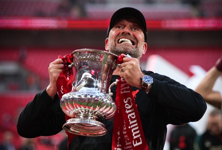 Jurgen Klopp, Manager of Liverpool celebrates with the Emirates FA Cup trophy.