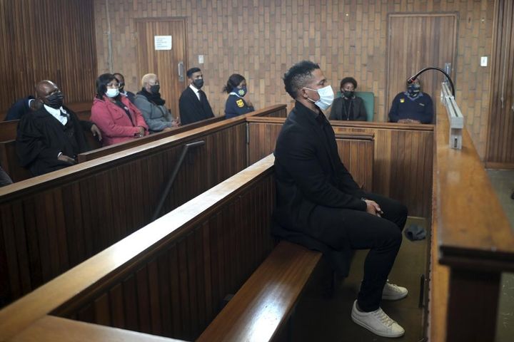 South Africa rugby player Elton Jantjies, center, appears in Kempton Park magistrates court in Johannesburg on May 16. Jantjies was arrested for allegedly causing damage to an aircraft during a flight home from a vacation in Turkey.