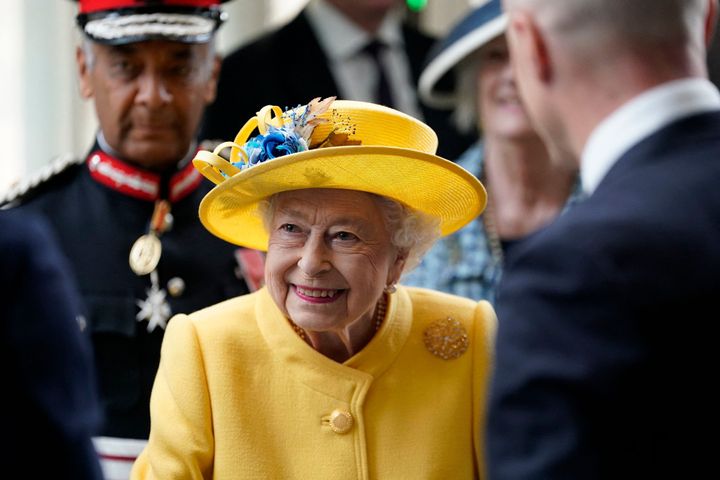 Queen Elizabeth reacts during her visit to Paddington Station in London.