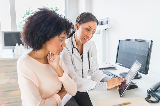 A doctor speaking to her patient