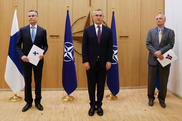 Finland's Ambassador to NATO Klaus Korhonen, left, NATO Secretary-General Jens Stoltenberg and Sweden's Ambassador to NATO Axel Wernhoff attend a ceremony on Wednesday to mark Sweden's and Finland's application for membership. (Johanna Geron/Pool via AP)