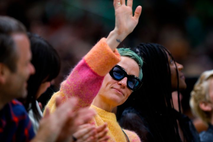 Soccer player Megan Rapinoe waves to the crowd during the second quarter of a WNBA basketball game between the Minnesota Lynx and the Seattle Storm on on May 6, 2022, in Seattle.