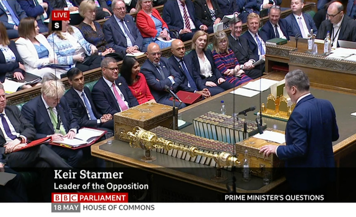 Rees-Mogg (fourth from the right on the front bench) did smile at Starmer's comment