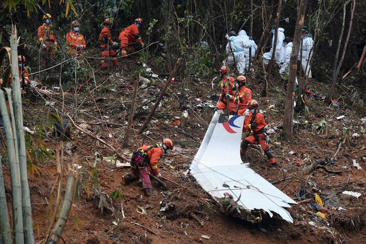 Search-and-rescue workers search through debris at the China Eastern flight crash site on March 24.