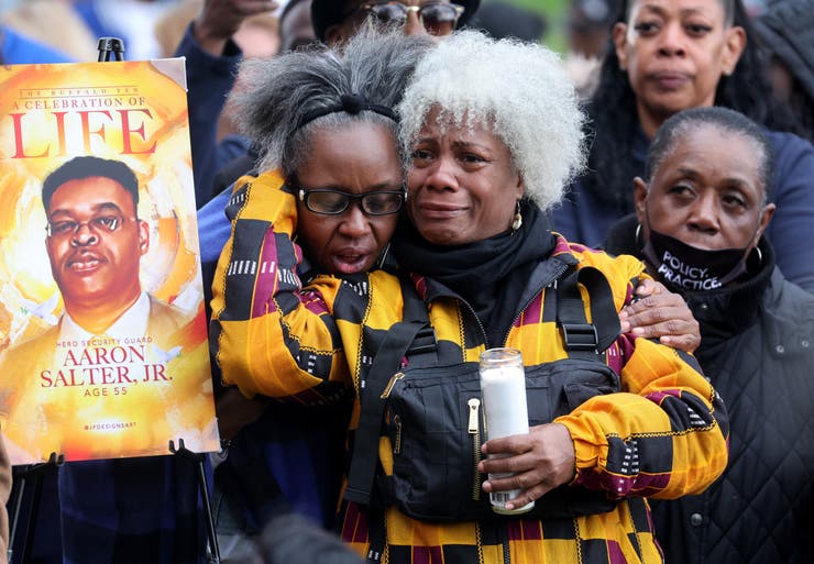 People participate in a vigil to honor the 10 people killed in Saturday's shooting at Tops market on May 17 in Buffalo, New York.
