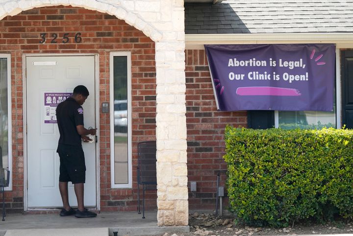 A security guard opens the door to the Whole Women's Health Clinic in Fort Worth, Texas, on Sept. 1, 2021. Texas has released data showing a marked drop in abortions at clinics in the state in the first month under the nation's strictest abortion law.