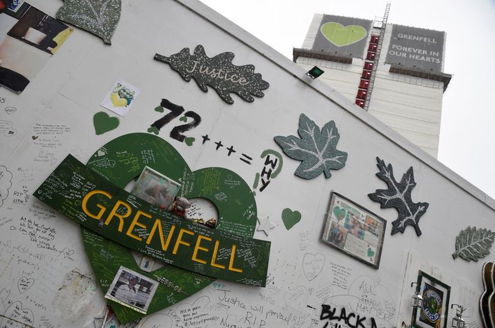 Messages of condolence are seen on temporary hoardings and on the covered remains of the Grenfell Tower in January.
