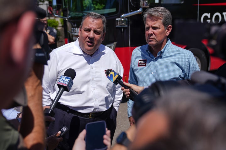 Former New Jersey Gov. Chris Christie (left) and Gov. Brian Kemp talk to the media at a campaign event on May 17, 2022 in Canton, Georgia. Kemp touted a one-time tax refund included in the state budget he signed last week on a statewide bus tour to meet and talk with voters ahead of the May 24 primary.