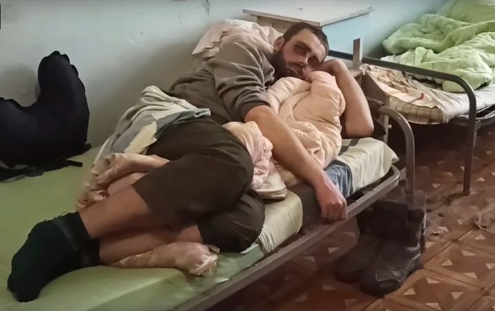 In this photo taken from video released by the Russian Defense Ministry on May 18, 2022, shows a wounded Ukrainian servicemen lying in a hospital in Novoazovsk, Ukraine, in territory under the government of the Donetsk People's Republic, after he an his comrades were evacuated from Azovstal steel plant in Mariupol. 