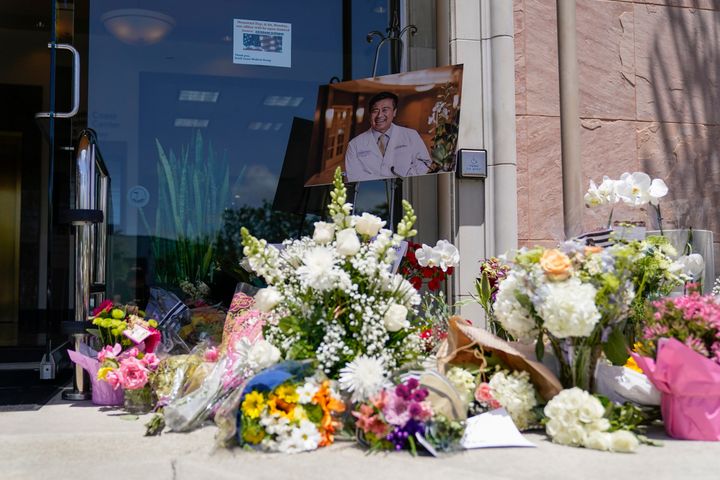 A memorial honoring Dr. John Cheng sits outside his office building on May 17, 2022, in Aliso Viejo, Calif. Cheng, 52, was killed in Sunday's shooting at Geneva Presbyterian Church.