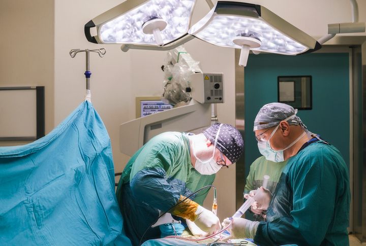 Neurosurgeon team operating brain tumor surgery in hospital operating room