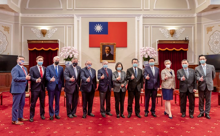 In this photo released by the Taiwan Presidential Office, members of an American Congressional delegation, from left, Rep. Ronny Jackson, R-Texas, Sen. Ben Sasse, R-Neb., Sen. Rob Portman, R-Ohio, Sen. Richard Burr, R-N.C., Sen. Bob Menendez, D-N.J., and Sen. Lindsey Graham, R-S.C., pose for a photo with Taiwan's President Tsai Ing-wen, center right, and other Taiwanese officials during a meeting at the Presidential Office in Taipei, Taiwan, on April 15, 2022.