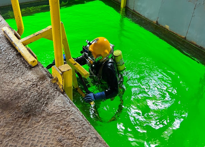 Donnie Gibbons, a commercial diver and member of Piledrivers and Divers Local 474, enters the water at Eastern Atlantic States Regional Council of Carpenters' newly acquired dive school in Sicklerville, New Jersey. The complex and adjacent lake, a former quarry, is the first union-owned commercial dive school in the nation. 