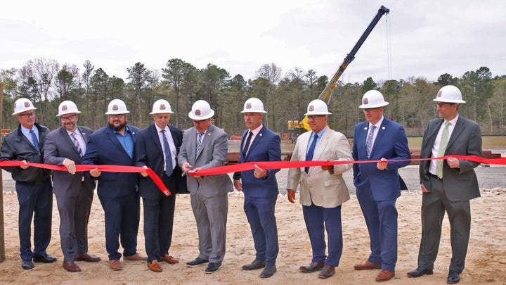 William Sproule cuts the ribbon during a May 11 open house at the carpenters union's upgraded heavy construction and offshore wind training facility.