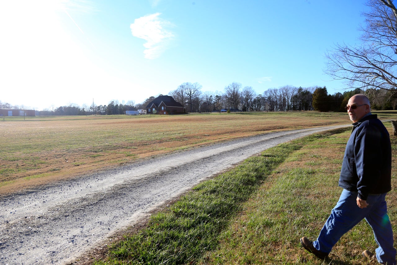 Brian Harper, a local business owner, walks between his home and his sister-in-law’s on their properties in Cherryville, North Carolina.