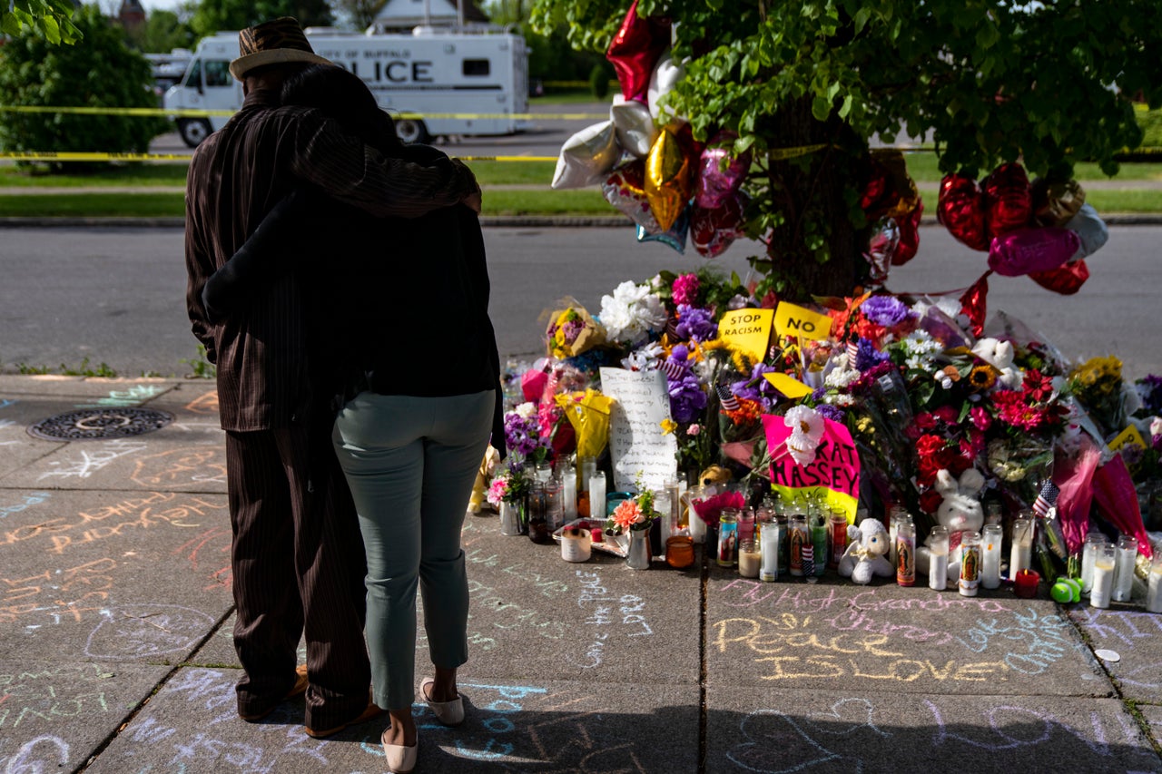 Residents pay their respects at a makeshift memorial across the street from Tops Friendly Market on Wednesday, May 18, 2022 in Buffalo, New York. 