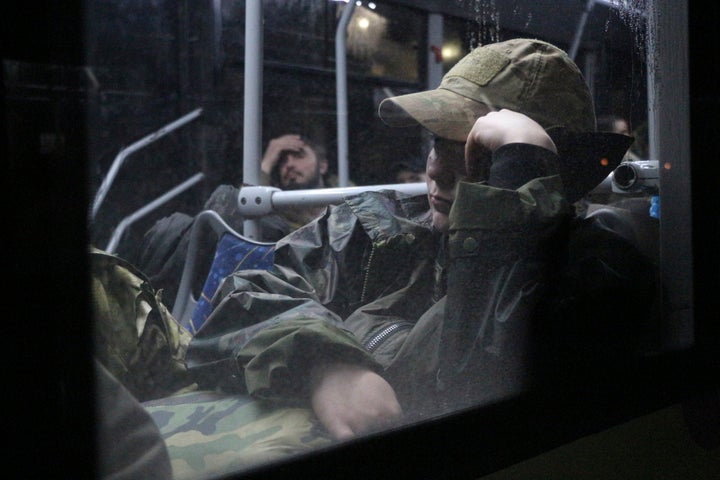 Ukrainian servicemen sit in a bus after leaving Mariupol's besieged Azovstal steel plant, near a penal colony, in Olyonivka, in territory under the government of the Donetsk People's Republic, eastern Ukraine, on May 20, 2022.