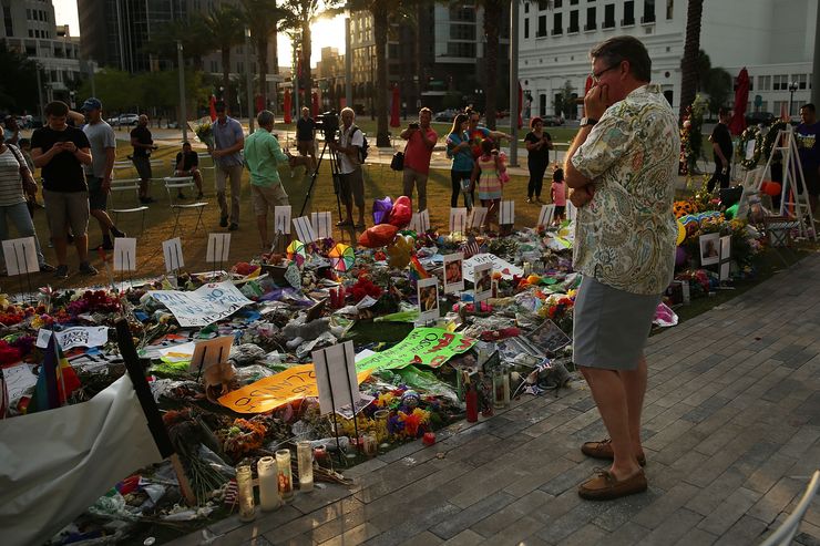 People visit a memorial for those killed at Pulse nightclub on June 16, 2016 in Orlando, Florida.