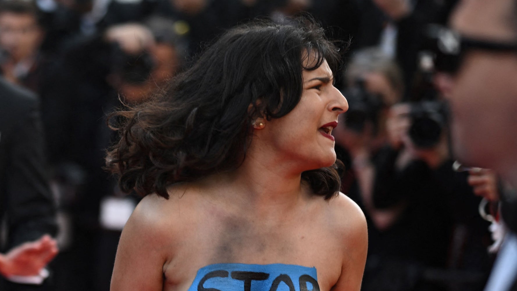 Woman Strips On Cannes Red Carpet To Protest Russian Rapes In Ukraine Woman Strips On Cannes Red Carpet To Protest Russian Rapes In Ukraine