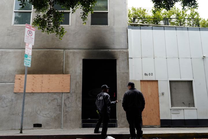 Los Angeles Fire City investigators check the smoked exterior of a Hollywood recording studio.